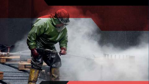 Person doing industrial cleaning wearing protective gear